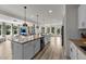 Large kitchen island is the focal point, connecting to a cozy living area with a view to the outdoors at 185 Twilight Trl, Willow Springs, NC 27592