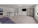 Spacious upstairs loft features a stylish bookshelf and television at 185 Twilight Trl, Willow Springs, NC 27592