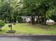 Charming single-story home with a lush front lawn and mature trees, creating a welcoming curb appeal at 203 Lane Of Sir Kay, Garner, NC 27529