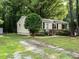 Cozy home with a well-kept lawn, adorned with a mature tree and decorated with an American flag at 203 Lane Of Sir Kay, Garner, NC 27529