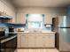 Bright kitchen with stainless steel refrigerator, updated cabinets, and eat-in area at 203 Lane Of Sir Kay, Garner, NC 27529