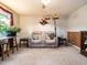 Comfortable living room featuring a reclining sofa, soft carpet, and a bright window with sheer curtains at 203 Lane Of Sir Kay, Garner, NC 27529
