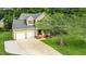 Scenic aerial view of a well-maintained home with a long driveway and beautifully landscaped yard at 2218 Watersglen Dr, Apex, NC 27502