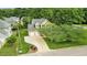 A home with a well maintained lawn, mature shade trees, and ample parking, as seen from above at 2218 Watersglen Dr, Apex, NC 27502