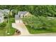 The home has a 2 car garage and manicured lawn in a neighborhood filled with mature trees at 2218 Watersglen Dr, Apex, NC 27502