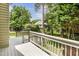 A well maintained back deck overlooking a green yard and mature trees creates a relaxing outdoor space at 2218 Watersglen Dr, Apex, NC 27502