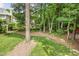 A tree lined backyard with a freshly mowed lawn, with mature trees scattered throughout the yard at 2218 Watersglen Dr, Apex, NC 27502