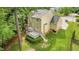 Backyard with deck and green lawn surrounded by mature trees at 2218 Watersglen Dr, Apex, NC 27502