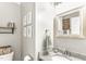Cozy bathroom featuring neutral gray walls, framed plant pictures, and stylish sink and mirror at 2218 Watersglen Dr, Apex, NC 27502