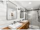 Modern bathroom with double sink vanity, shiplap wall, and large tiled glass shower at 2218 Watersglen Dr, Apex, NC 27502