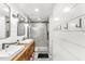 Stylish bathroom with double vanity, shiplap accent wall, and modern glass shower at 2218 Watersglen Dr, Apex, NC 27502
