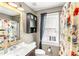 Bathroom with floral shower curtain, vanity, mirror, and cabinet at 2218 Watersglen Dr, Apex, NC 27502