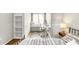 Bright bedroom featuring a metal bed frame, desk, window seat and neutral decor at 2218 Watersglen Dr, Apex, NC 27502