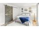 Stylish bedroom with wood-look floors, a sliding barn door, and modern accents at 2218 Watersglen Dr, Apex, NC 27502