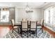 Elegant dining room features a stylish chandelier, gray walls, and hardwood floors at 2218 Watersglen Dr, Apex, NC 27502