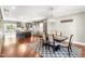 Open-concept dining area with hardwood floors and seamlessly flowing into the kitchen and living spaces at 2218 Watersglen Dr, Apex, NC 27502