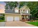Attractive two-story home boasting a two-car garage, covered front porch and manicured landscaping at 2218 Watersglen Dr, Apex, NC 27502