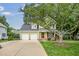 Inviting two-story home with a spacious driveway, lush lawn, and mature landscaping at 2218 Watersglen Dr, Apex, NC 27502
