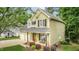 Charming two-story home featuring a cozy front porch and a two-car attached garage at 2218 Watersglen Dr, Apex, NC 27502