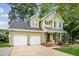 Charming two-story home with a two-car garage, covered porch and manicured landscaping at 2218 Watersglen Dr, Apex, NC 27502
