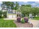 Beautiful two-story home with a two-car garage and lush front yard landscaping at 2218 Watersglen Dr, Apex, NC 27502