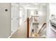Bright hallway with plush carpet, stairway, reading nook, neutral walls, and white doors at 2218 Watersglen Dr, Apex, NC 27502