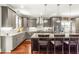 Well-appointed kitchen with granite counters, stainless appliances, large island with seating and ample lighting at 2218 Watersglen Dr, Apex, NC 27502
