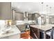 Well-designed kitchen boasts granite counters, stainless appliances, ample cabinet space and hardwood floors at 2218 Watersglen Dr, Apex, NC 27502