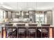 Bright kitchen with granite counters, stainless appliances, large island with seating and custom cabinets at 2218 Watersglen Dr, Apex, NC 27502