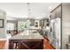 Open kitchen boasts granite counters, stainless appliances, a large island, and access to outdoor space at 2218 Watersglen Dr, Apex, NC 27502