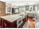 Modern kitchen featuring granite counters, stainless appliances, kitchen island, and an eat-in dining area at 2218 Watersglen Dr, Apex, NC 27502