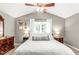 The bright bedroom has a ceiling fan, a large window, and neutral paint at 2218 Watersglen Dr, Apex, NC 27502