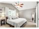 Bright main bedroom with vaulted ceilings, ceiling fan, natural light, and sliding barn door at 2218 Watersglen Dr, Apex, NC 27502