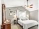 Inviting bedroom featuring neutral gray walls, ceiling fan, bright window, and a comfortable bed at 2218 Watersglen Dr, Apex, NC 27502