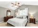 Neutral bedroom with vaulted ceilings, ceiling fan, natural light, and wood furniture at 2218 Watersglen Dr, Apex, NC 27502