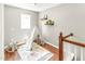 Cozy playroom with toy teepee, shelving, hardwood floors, a window, and neutral walls at 2218 Watersglen Dr, Apex, NC 27502
