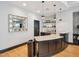 Wet bar area featuring counter seating, sink and decorative backsplash and lighting at 222 Glenwood Ave # 213, Raleigh, NC 27603