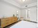 Spacious bedroom featuring wood-look floors, white walls, and a bathroom with a connecting door at 222 Glenwood Ave # 213, Raleigh, NC 27603