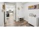 Inviting entryway featuring hooks for hats, a bench for shoes, and an opening to the kitchen at 222 Glenwood Ave # 213, Raleigh, NC 27603