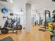 Community fitness center with modern equipment and multiple ceiling fans at 222 Glenwood Ave # 213, Raleigh, NC 27603