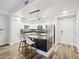 Stylish kitchen with white cabinets, stainless steel appliances, and bar stool seating at the island at 222 Glenwood Ave # 213, Raleigh, NC 27603