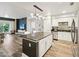 Modern kitchen with stainless appliances, granite countertops, and an island with bar seating at 222 Glenwood Ave # 213, Raleigh, NC 27603