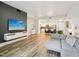 Open-concept living room with a modern TV setup and a view into the kitchen at 222 Glenwood Ave # 213, Raleigh, NC 27603