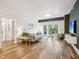 Sun-lit living room featuring stylish decor, wood floors, and a cozy gray sofa at 222 Glenwood Ave # 213, Raleigh, NC 27603