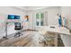 Office space featuring monitors, white walls, wood-look floors, and a large window with natural light at 222 Glenwood Ave # 213, Raleigh, NC 27603