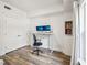 Office space featuring monitors, white walls, wood-look floors, and a large window with natural light at 222 Glenwood Ave # 213, Raleigh, NC 27603