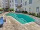 Outdoor community pool with lounge chairs and lush landscaping at 222 Glenwood Ave # 213, Raleigh, NC 27603