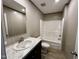 Bathroom includes shower-tub combo, commode, and modern vanity with large mirror at 2232 Tarboro Road Rd, Youngsville, NC 27596