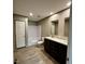 The bathroom has a shower and tub combo, double sink vanity, and neutral flooring at 2232 Tarboro Road Rd, Youngsville, NC 27596
