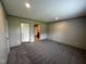 This bedroom boasts neutral walls, and plush carpet flooring at 2232 Tarboro Road Rd, Youngsville, NC 27596